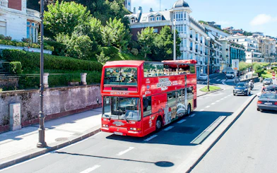 Red double-decker bus on San Sebastian city tour route.