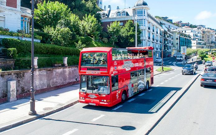 Red double-decker bus on San Sebastian city tour route.