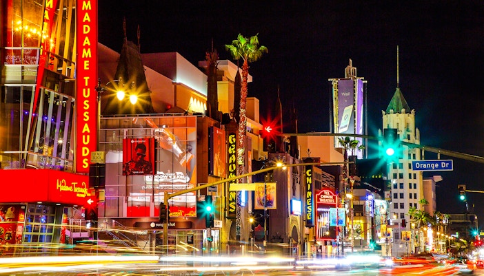 Madame Tussauds Hollywood entrance at night with neon lights on Hollywood Boulevard.