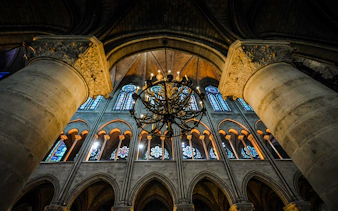 Sainte Chapelle interior with stained glass windows and ornate chandelier.