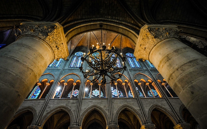 Sainte Chapelle interior with stained glass windows and ornate chandelier.