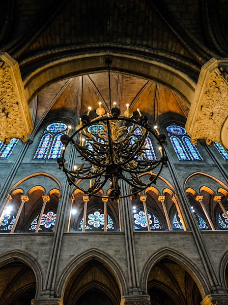 Sainte Chapelle interior with stained glass windows and ornate chandelier.