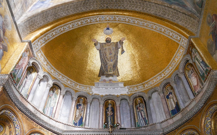 Mosaic ceiling inside St. Mark's Basilica, Venice, featuring religious figures and gold detailing.