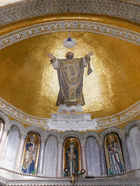 Mosaic ceiling inside St. Mark's Basilica, Venice, featuring religious figures and gold detailing.