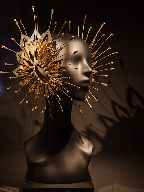 Sculpture with intricate gold spikes at ArtScience Museum exhibit.