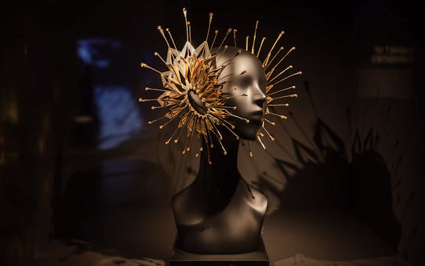 Sculpture with intricate gold spikes at ArtScience Museum exhibit.