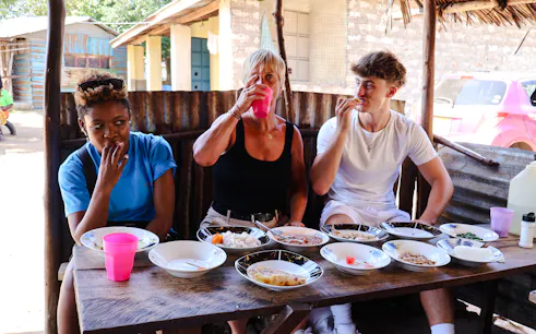Visitors enjoying local cuisine at a street food stall during the Diani Street Food and Market Tour.