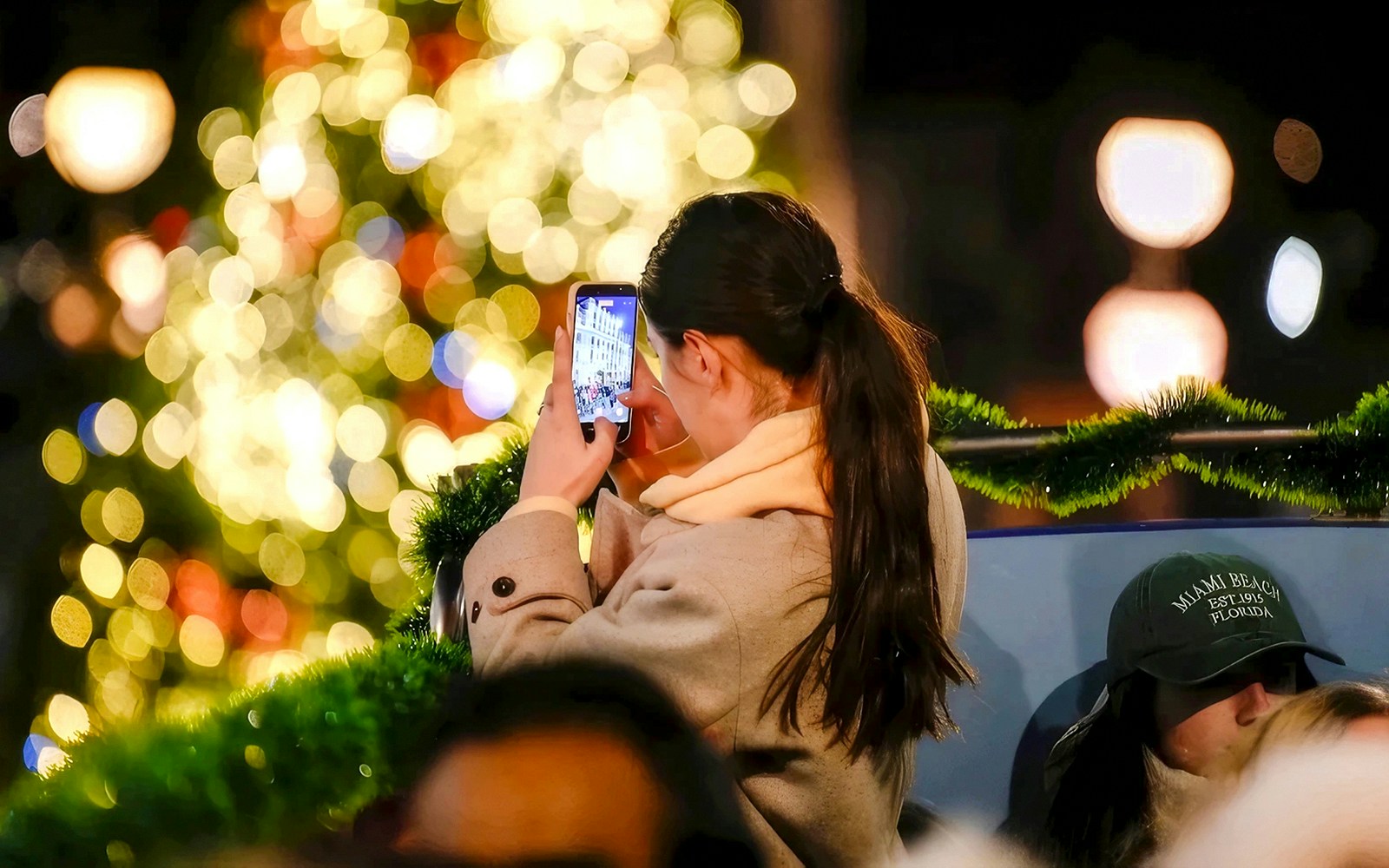 Person taking a photo of Christmas lights in London.