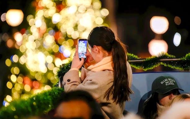 Person taking a photo of Christmas lights in London.