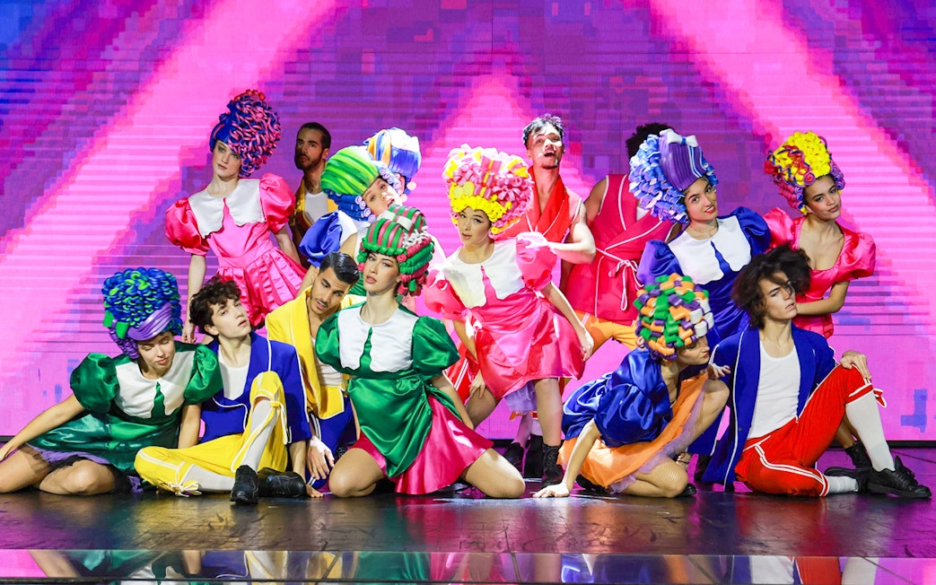Performers in colorful costumes on stage during Paris: My First Cabaret show.