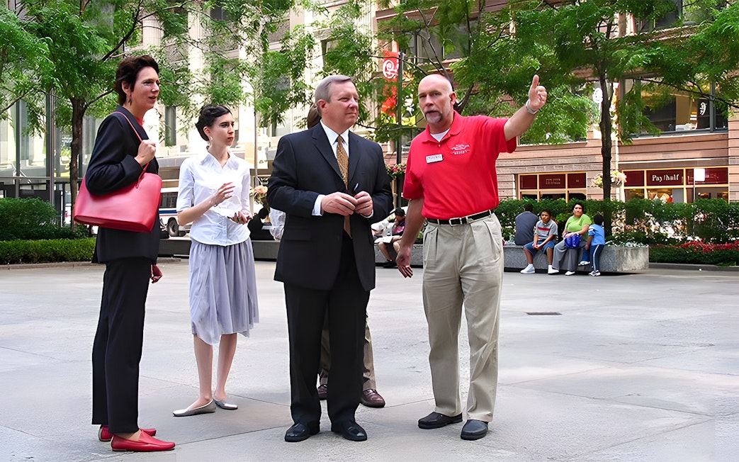 Tour guide explaining architecture to a group in Chicago's city center.
