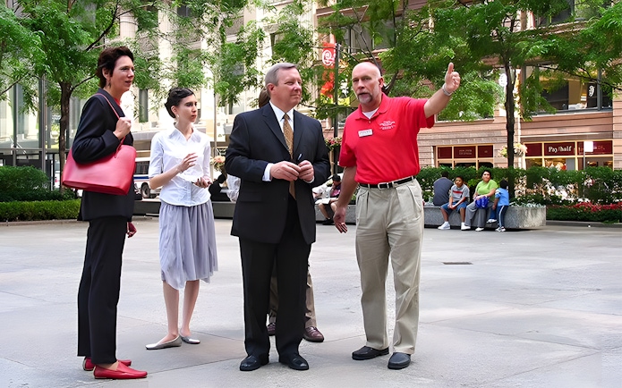 Tour guide explaining architecture to a group in Chicago's city center.