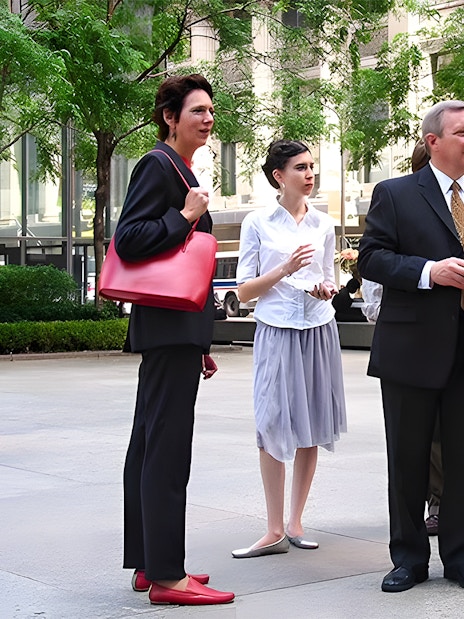 Tour guide explaining architecture to a group in Chicago's city center.