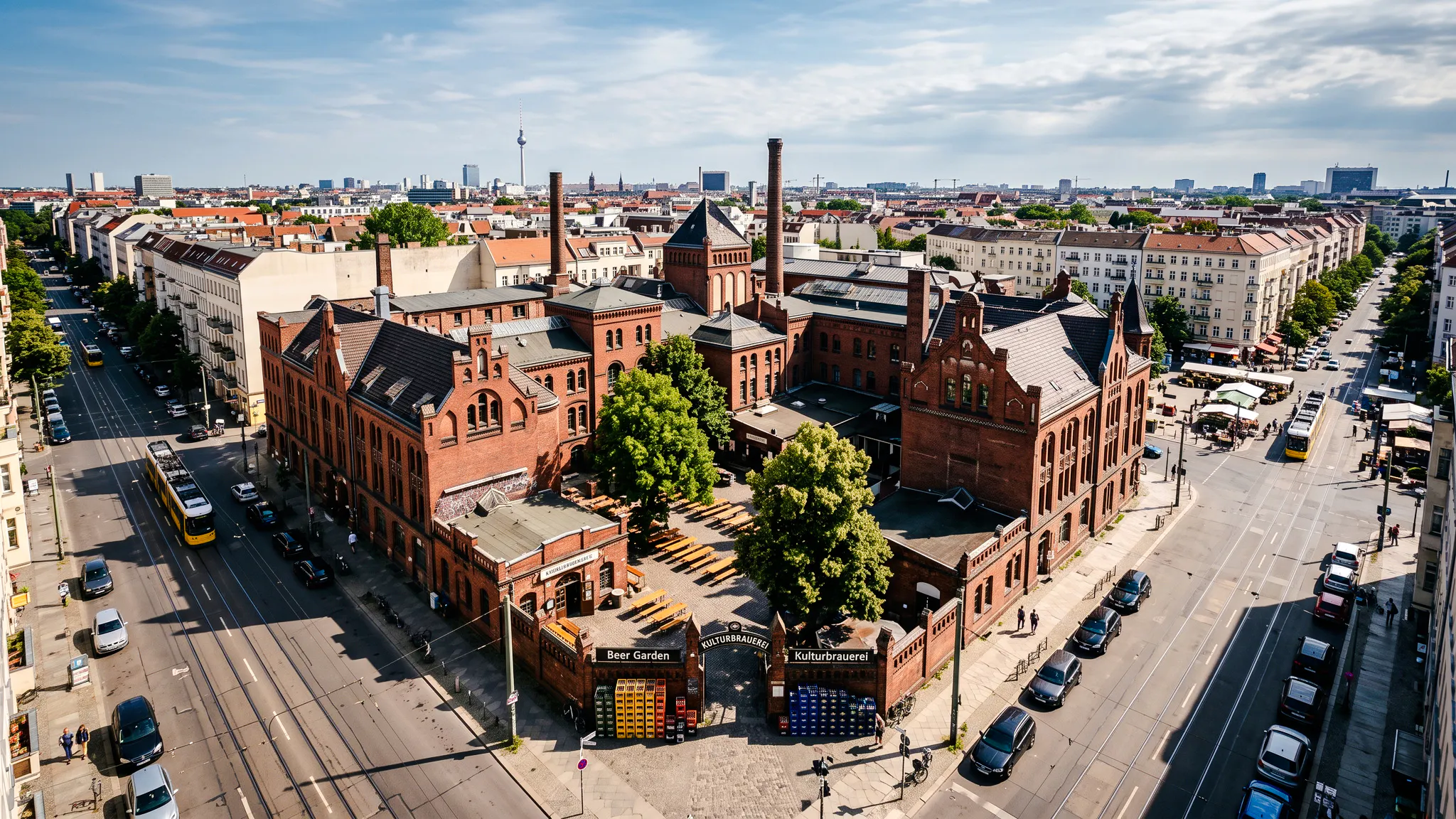 Kulturbrauerei complex in Berlin, featuring historic red brick buildings and a beer garden.