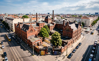 Kulturbrauerei complex in Berlin, featuring historic red brick buildings and a beer garden.