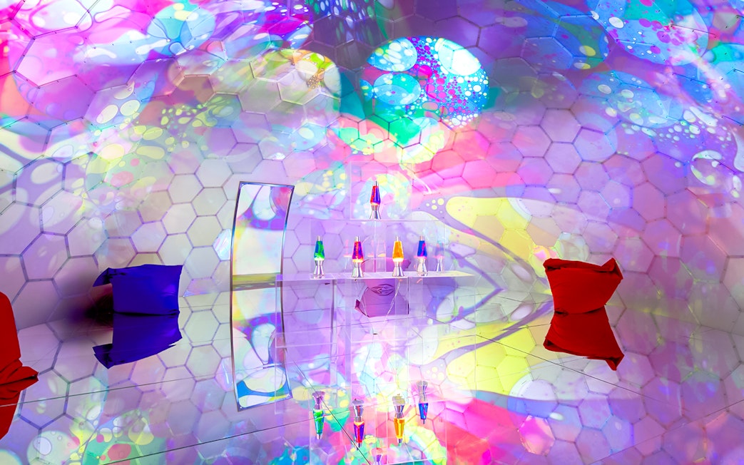 Colorful bubble-themed room with hexagonal patterns and lava lamps at Bubble Planet, Seattle.