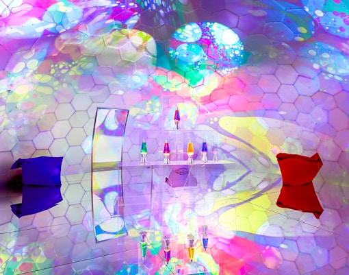 Colorful bubble-themed room with hexagonal patterns and lava lamps at Bubble Planet, Seattle.