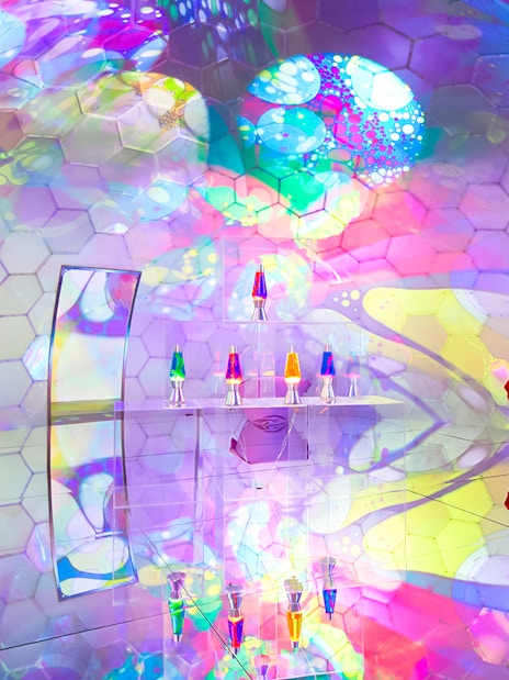 Colorful bubble-themed room with hexagonal patterns and lava lamps at Bubble Planet, Seattle.