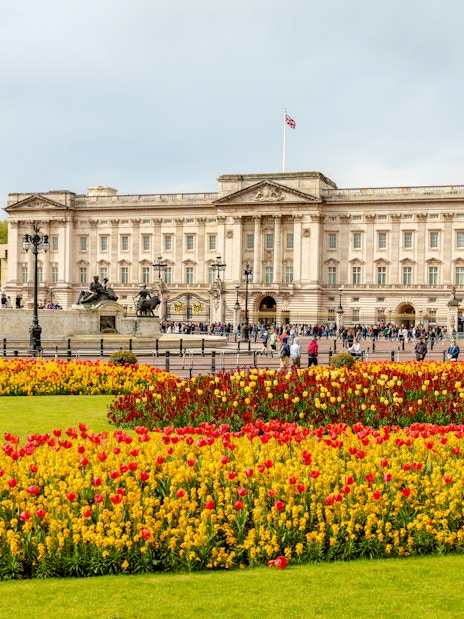Buckingham Palace with Victoria Memorial and colorful flower gardens in London.