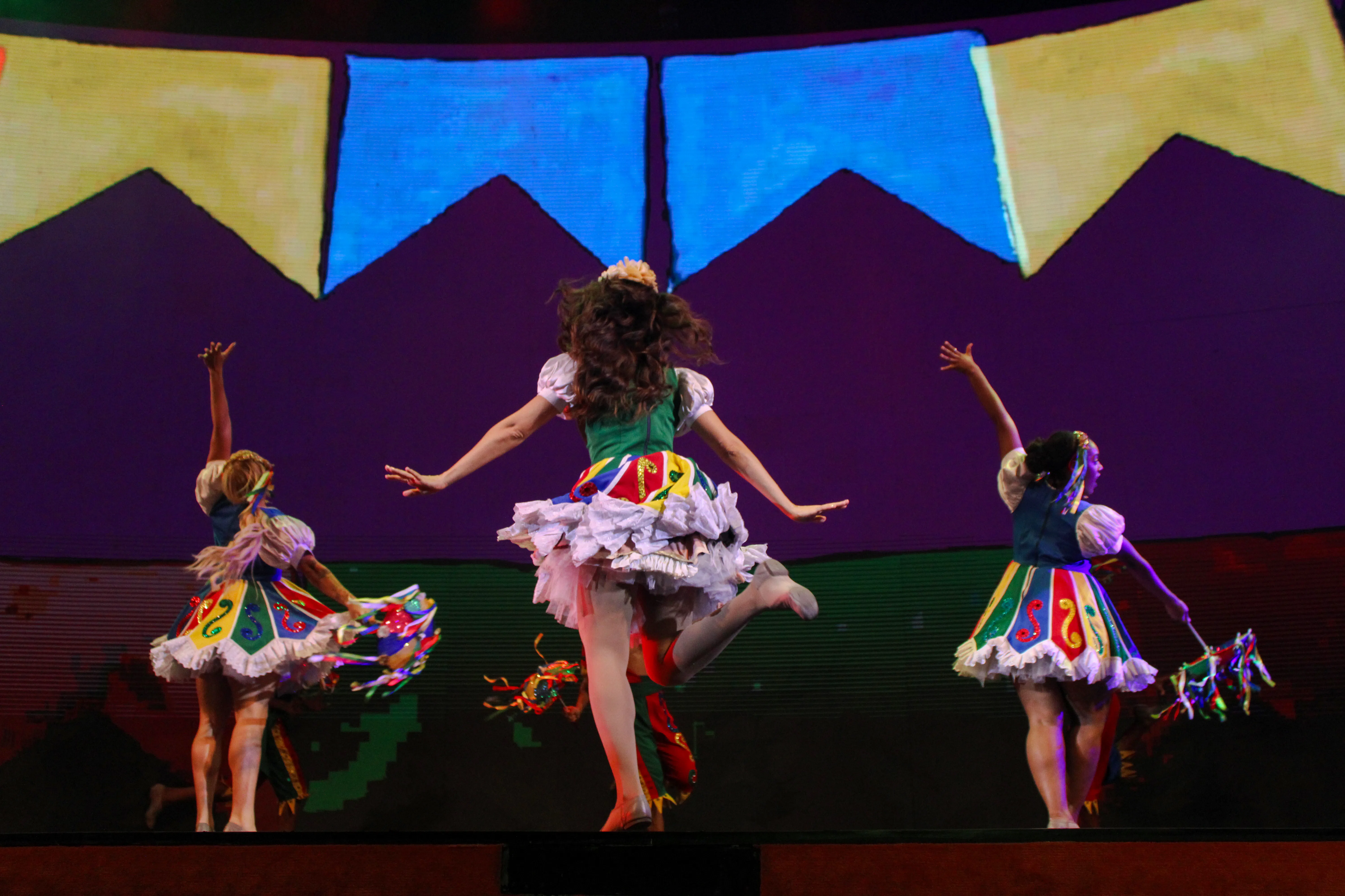 Performers in colorful costumes dancing at Roxy Dinner Show, Rio de Janeiro.
