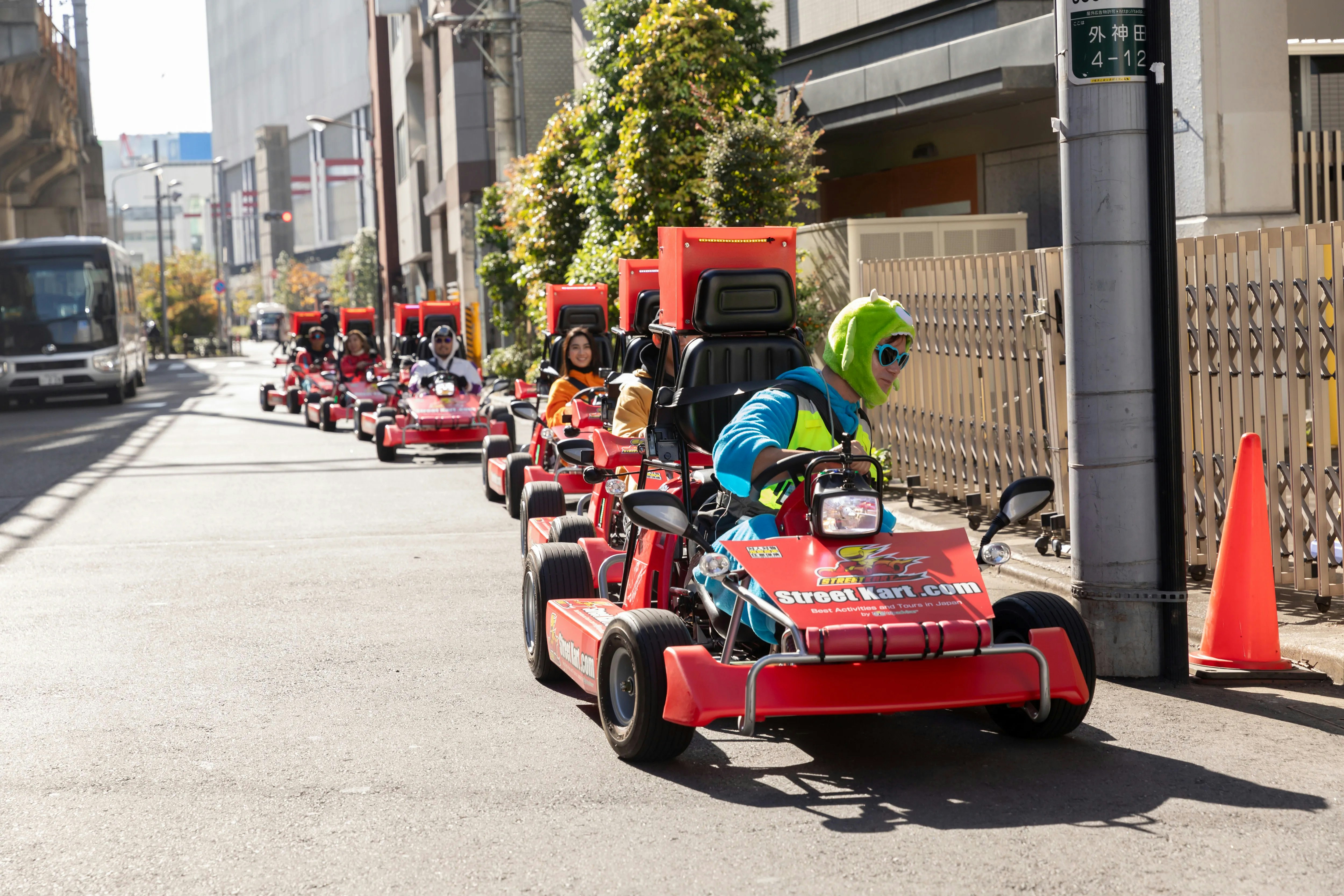 Tourists driving go karts on Shibuya streets during Tokyo go karting experience.