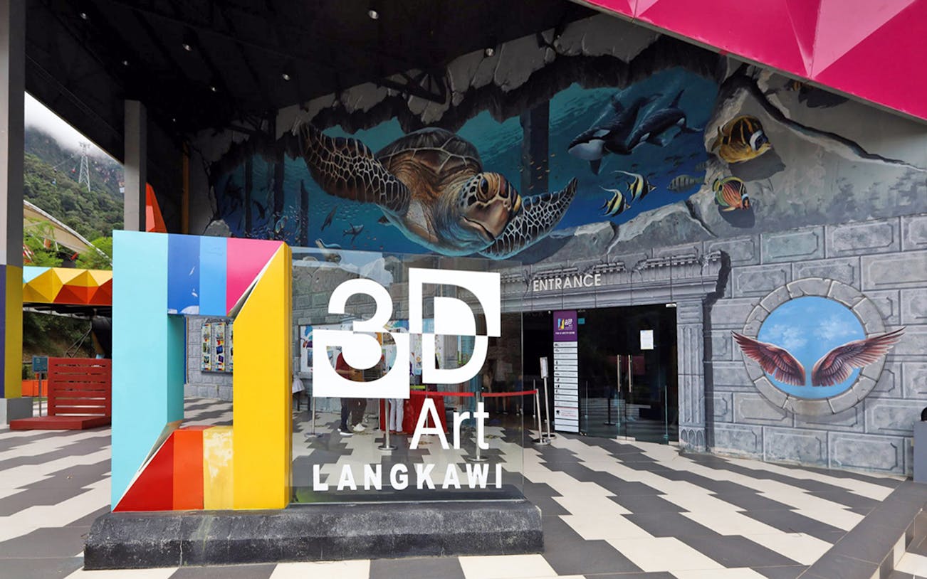 Langkawi 3D Art Museum entrance with colorful mural and cable car in background.