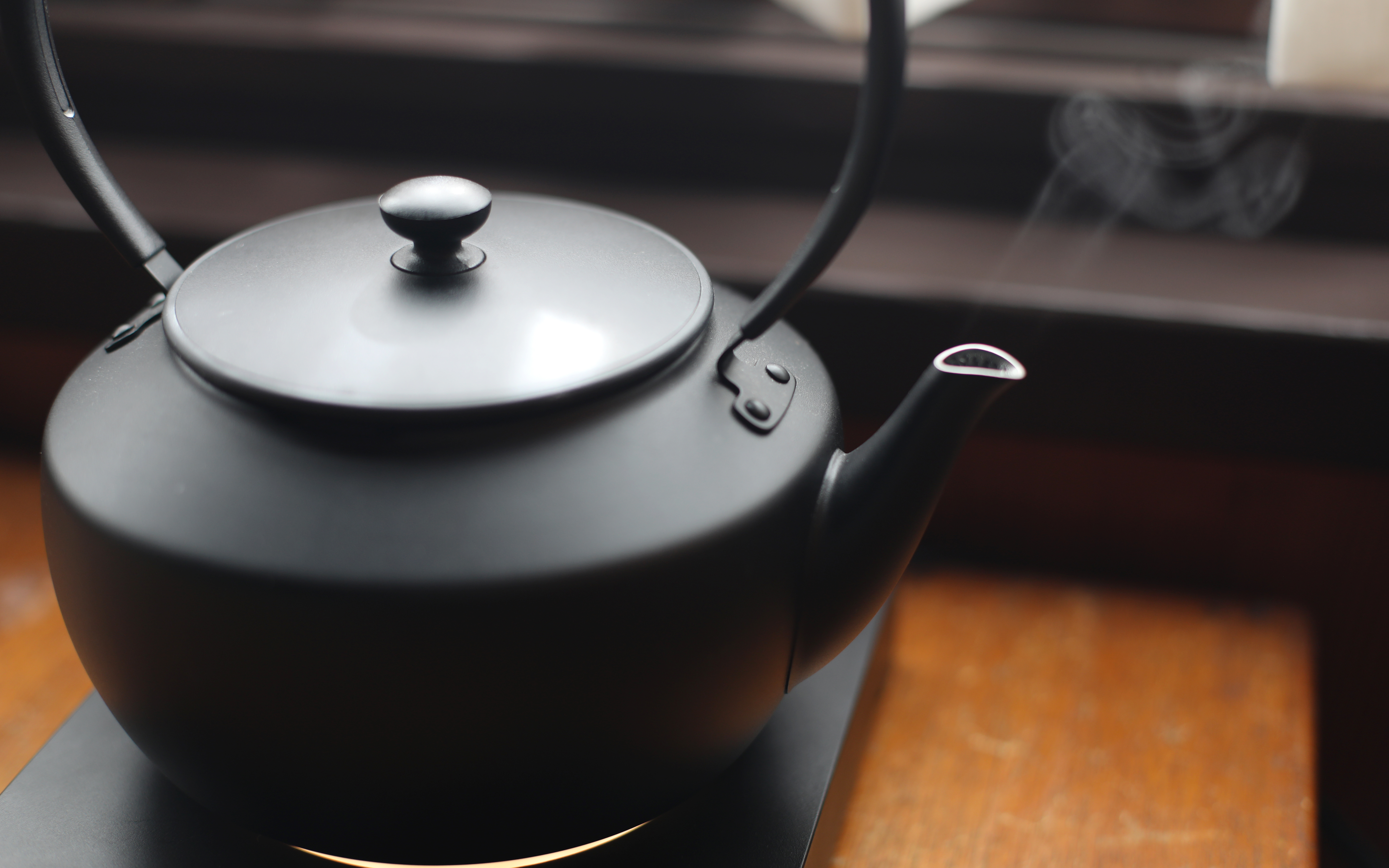 Electric kettle with steam rising, used for making tea.