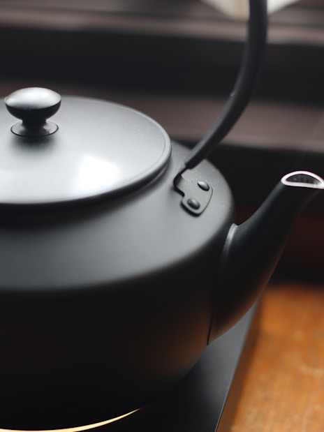 Electric kettle with steam rising, used for making tea.
