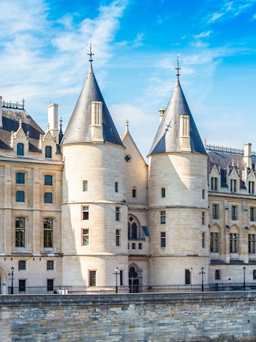 Conciergerie museum facade with towers in Paris, France.