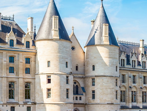 Conciergerie museum facade with towers in Paris, France.