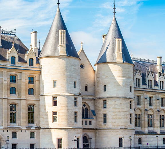 Conciergerie museum facade with towers in Paris, France.