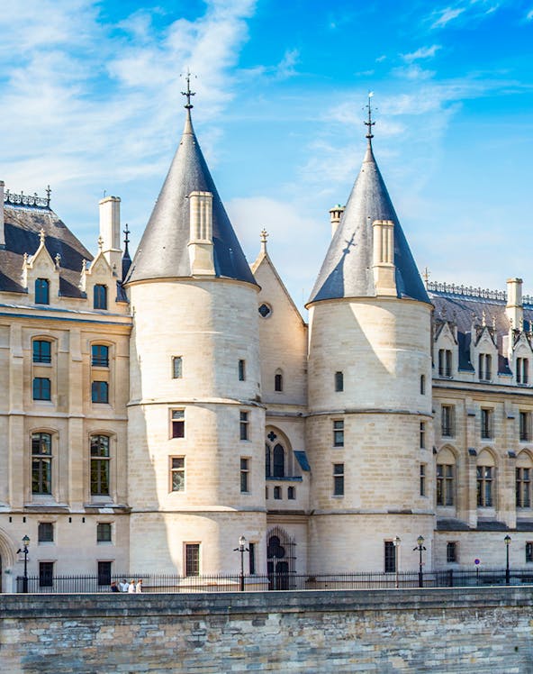 Conciergerie museum facade with towers in Paris, France.