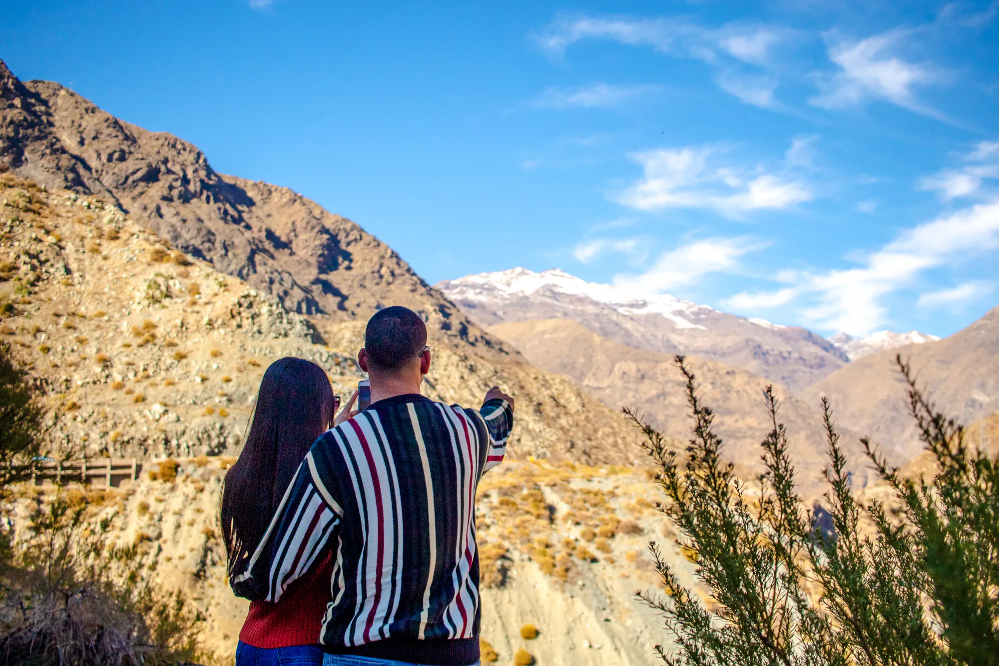 Couple admiring Andes mountains near Portillo, Santiago.