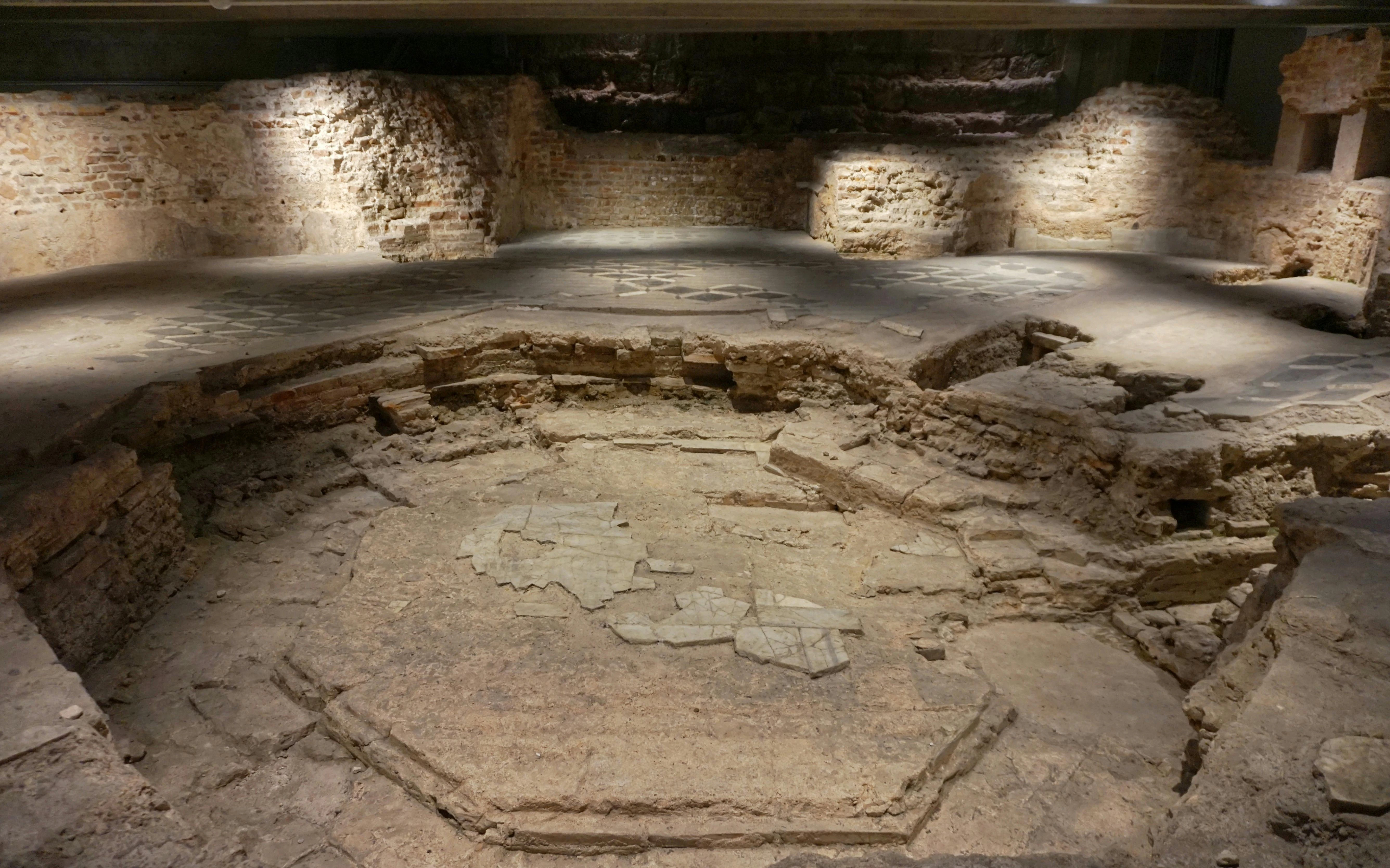 Archaeological ruins beneath the Duomo cathedral in Milan, showcasing ancient stonework.