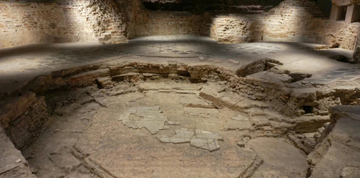 Archaeological ruins beneath the Duomo cathedral in Milan, showcasing ancient stonework.