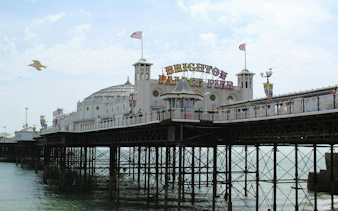 Brighton Palace Pier with seagull flying above, part of self-guided city exploration game in Brighton.