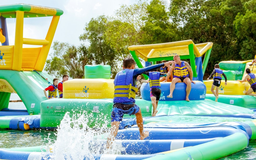 Visitors enjoying inflatable water park activities at HydroDash Singapore.