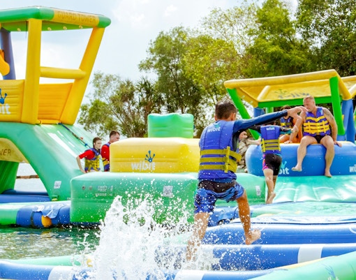 Visitors enjoying inflatable water park activities at HydroDash Singapore.