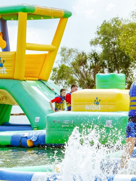Visitors enjoying inflatable water park activities at HydroDash Singapore.