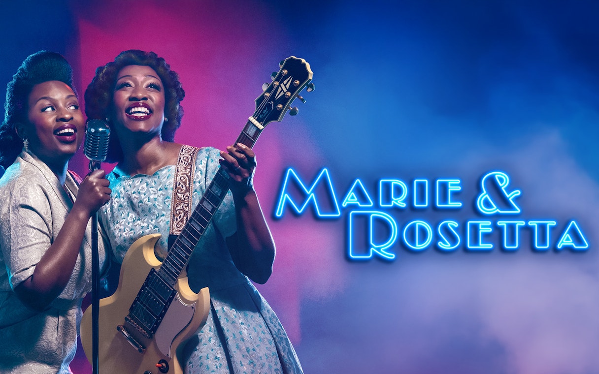 Two performers on stage with a guitar and microphone, Marie & Rosetta show.