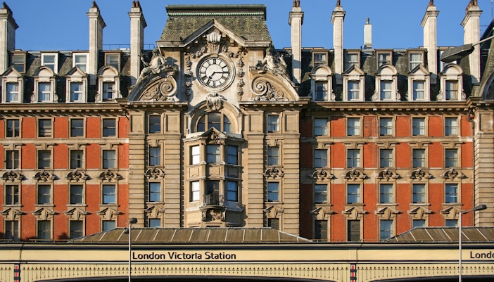 London Victoria Station facade with clock and architectural details.