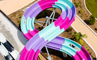 Colorful waterslide at Wet n Wild, Gold Coast with people sliding down.