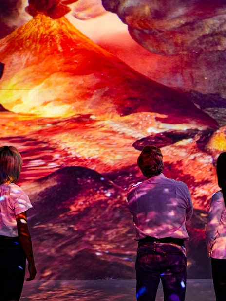 Visitors viewing Vesuvius eruption at Frameless Immersive experience.
