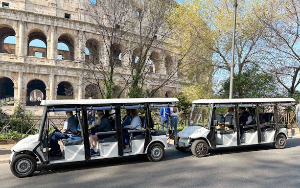 Golf carts in front of the Colosseum during a Rome tour.