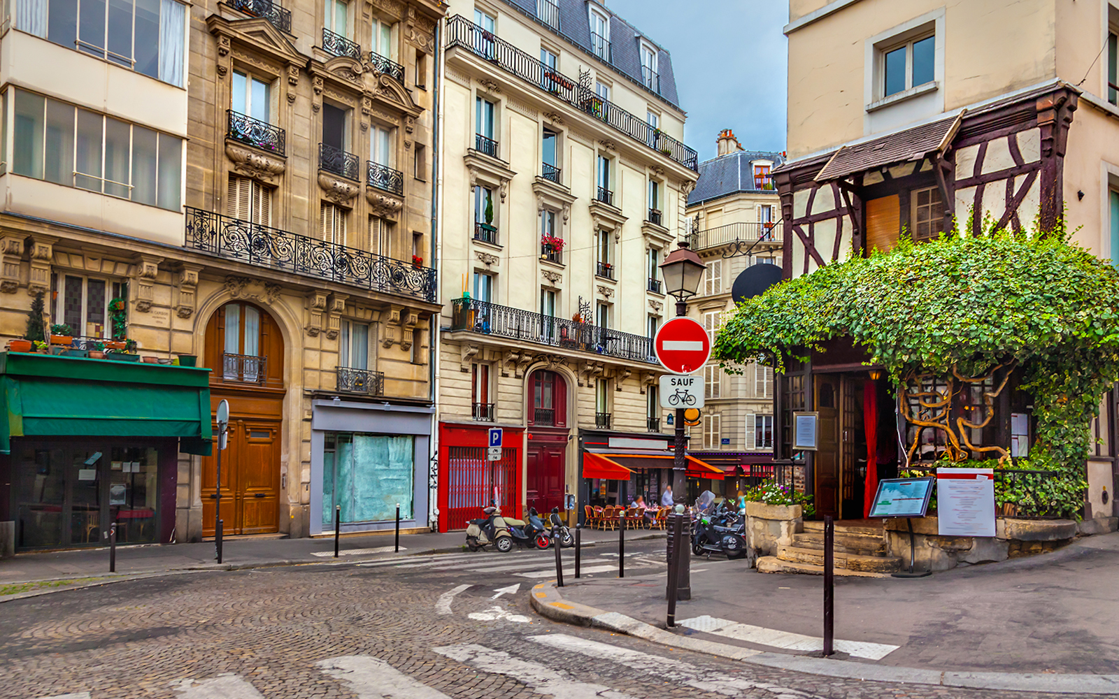Montmartre street with shops and cafes, Paris.