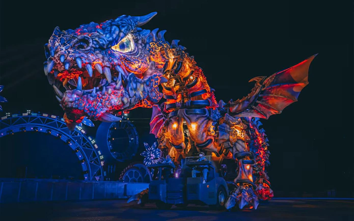 Giant dragon animatronic at Chimelong Paradise theme park, illuminated at night.