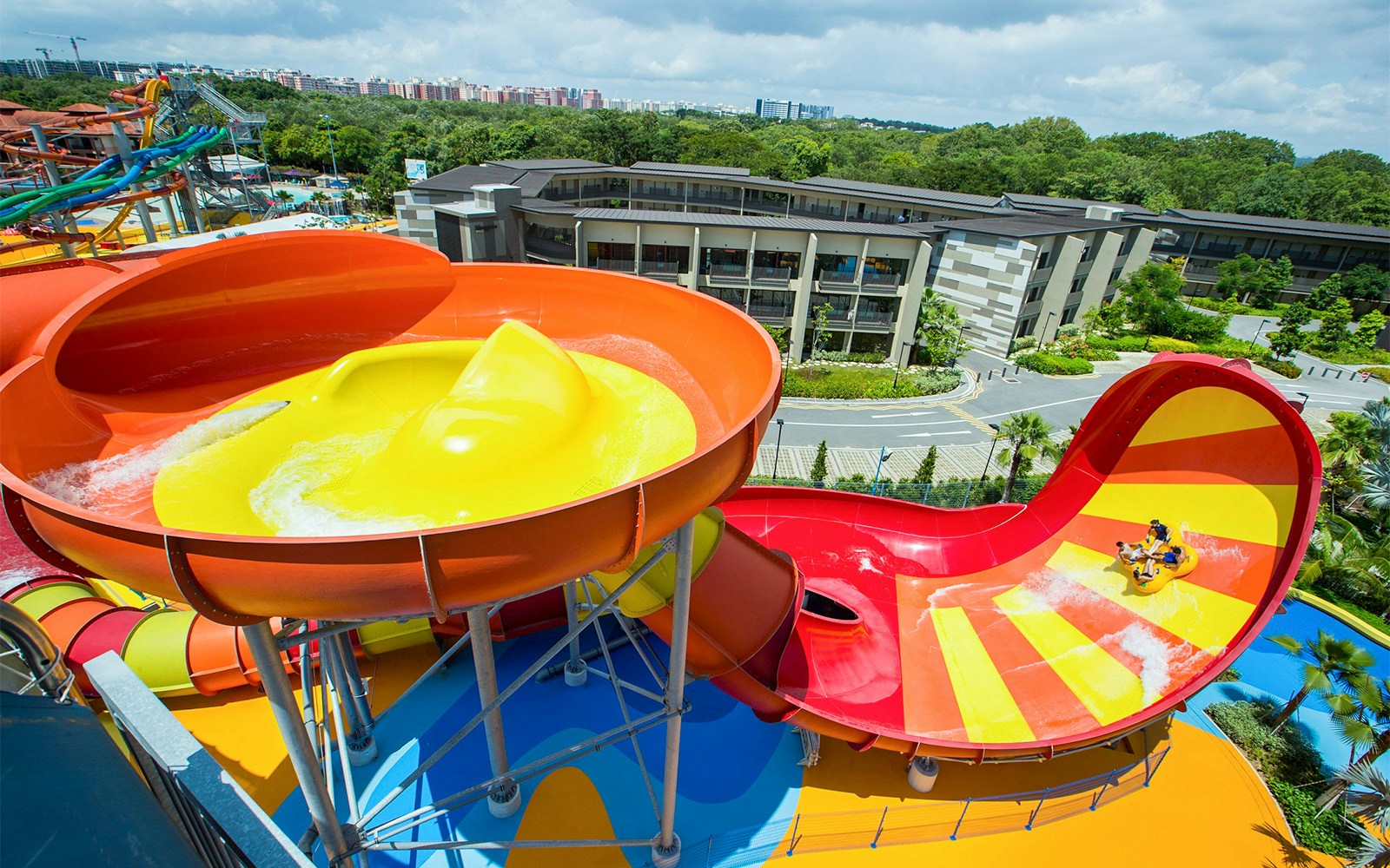 Water slides at Wild Wild Wet, Singapore, with riders on a raft.