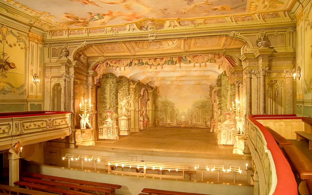 Baroque castle theatre interior in Cesky Krumlov with ornate stage and seating.