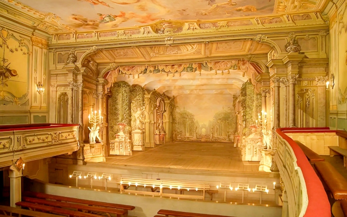 Baroque castle theatre interior in Cesky Krumlov with ornate stage and seating.