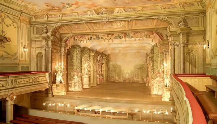 Baroque castle theatre interior in Cesky Krumlov with ornate stage and seating.